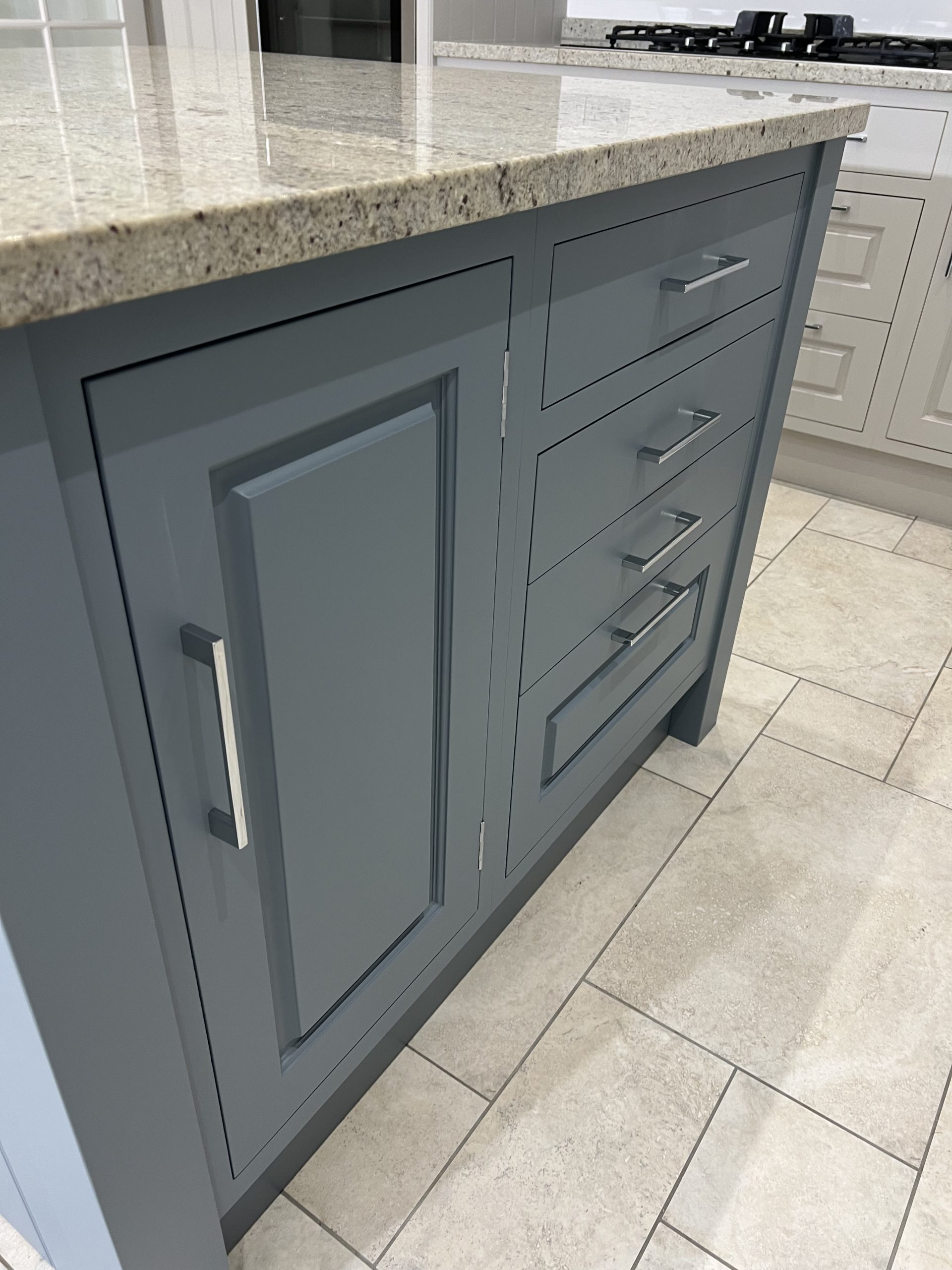 Close-up of a hand-painted shaker kitchen cabinet showing the smooth painted finish and traditional craftsmanship.