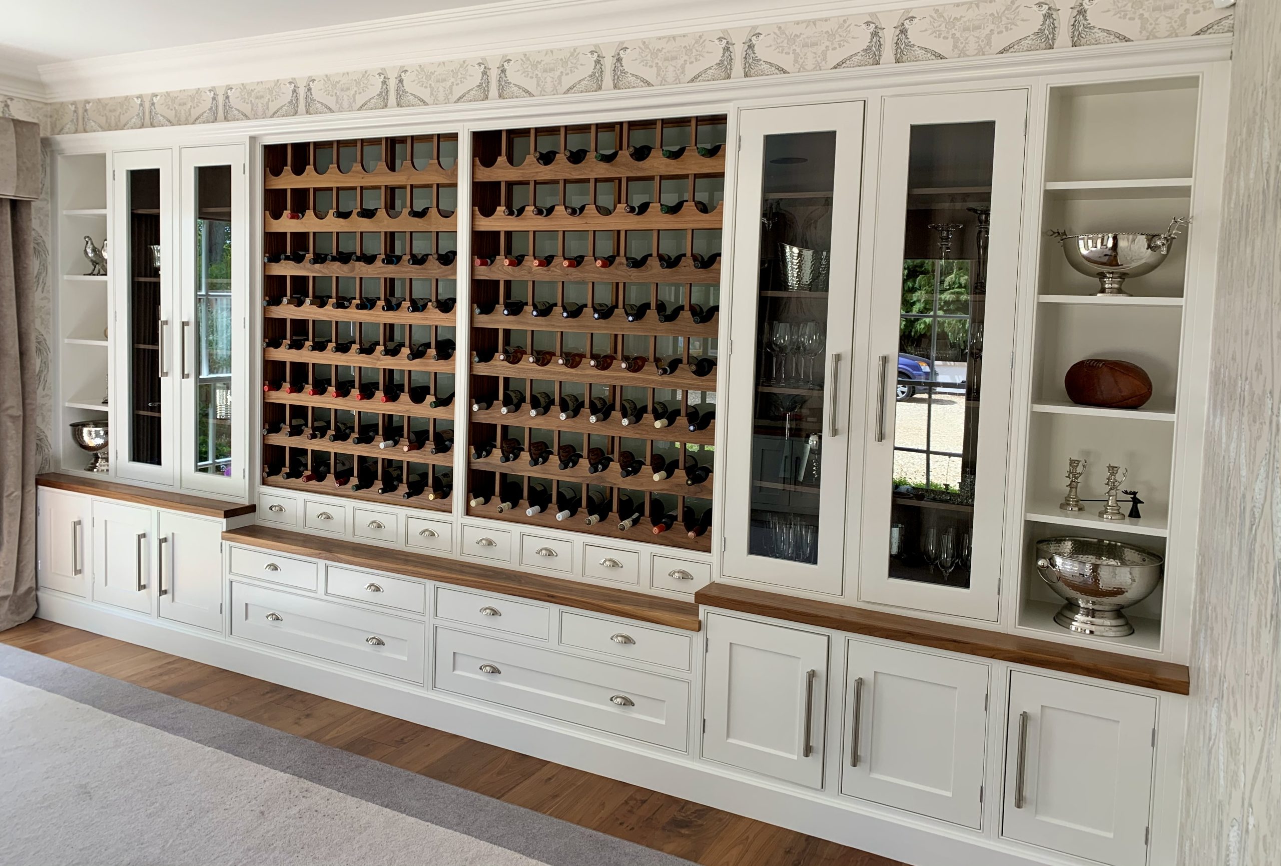 Hand-painted bespoke kitchen dresser with glazed cabinets, wine storage and traditional fitted joinery.