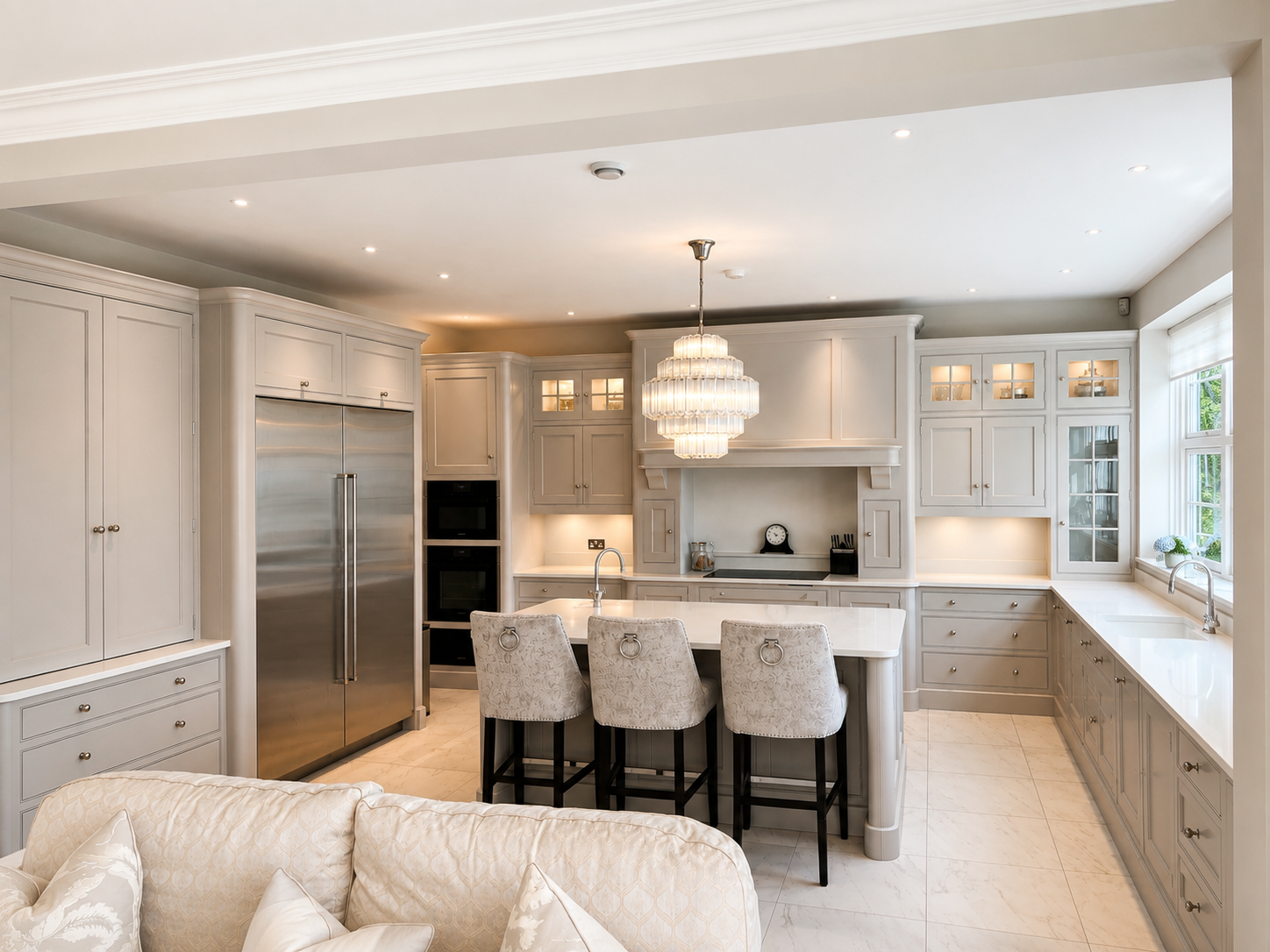 Hand-painted light grey shaker kitchen with a central island, integrated appliances and bespoke fitted cabinetry.